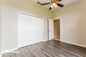 Kissimmee house for rent - a bedroom with a ceiling fan and a closet