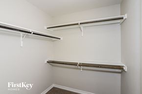 San Antonio house for rent - A white wall with two shelves on it.