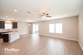 Jacksonville house for rent - A spacious room with wooden flooring and a ceiling fan.