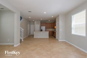 Riverview house for rent - A spacious empty room with a kitchen in the background.