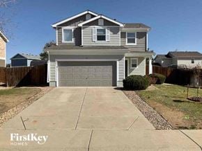Lochbuie house for rent - a house with a driveway and a garage door