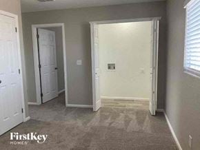 Lochbuie house for rent - an empty room with a white door and a window