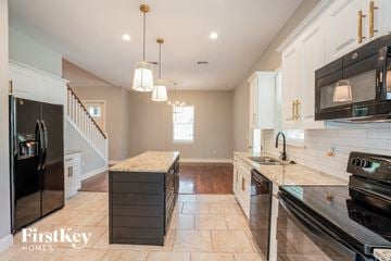 Plant City house for rent - a kitchen with stainless steel appliances and marble counter tops
