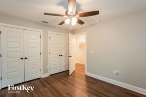 Plant City house for rent - a bedroom with two closets and a ceiling fan