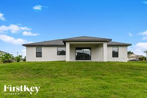 Lehigh Acres house for rent - a small white house with a grassy yard