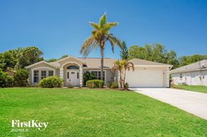 North Port house for rent - a house with a palm tree in front of it