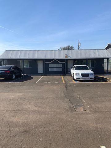 Phoenix apartment for rent - an empty parking lot in front of a building with a metal roof