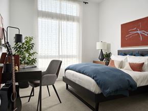 Lomita apartment for rent - Bedroom at Kaia South Bay with bed, guitar, and desk setup - ideal for work and relaxation