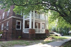 Norfolk apartment for rent - an old brick house with a porch and a tree