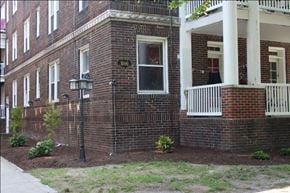 Norfolk apartment for rent - the front of a brick house with a porch and a lamp post