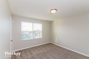 Saint Hedwig house for rent - a spacious bedroom with carpeted flooring and a window