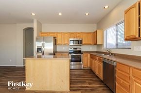 Laveen house for rent - a kitchen with wooden cabinets and stainless steel appliances