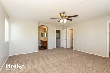 Laveen house for rent - a living room with carpet and a ceiling fan