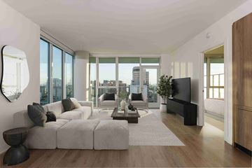 Long Beach apartment for rent - A modern living room with a large grey sofa and a wooden floor.