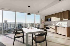 Long Beach apartment for rent - A modern kitchen with a dining table and chairs in front of a large window overlooking a cityscape.