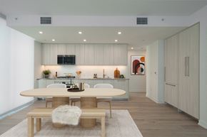 Long Beach apartment for rent - A modern dining room with a white table and bench.