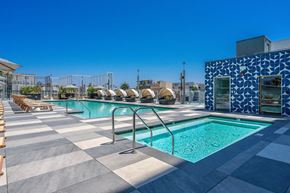 Long Beach apartment for rent - A pool with a blue tiled wall and a metal railing.