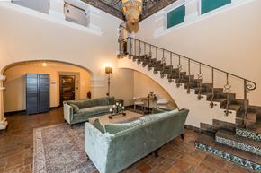 Oakland apartment for rent - A living room with a staircase and a couch.