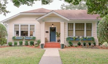 Camden apartment for rent - A small house with a blue door and windows with green plants on the windowsill.
