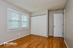 Maryland Heights house for rent - an empty bedroom with two doors and a wood floor