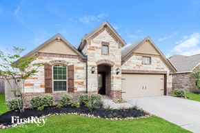 Conroe house for rent - A house with a stone facade and a garage door numbered 11.
