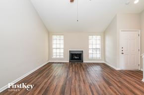 Houston house for rent - A room with a fireplace and wood flooring.