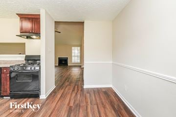 Houston house for rent - A kitchen with a wood floor and a stove top oven.