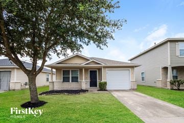 Humble house for rent - a white house with a tree in the front yard
