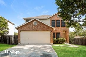 San Antonio house for rent - A brick house with a garage door and a sign that says "FirstKey Homes".