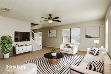 San Antonio house for rent - A living room with a black and white striped rug and a wooden coffee table.