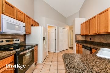 Davenport house for rent - a kitchen with granite counter tops and wooden cabinets