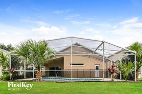 Davenport house for rent - a house with a pool and palm trees in front of it