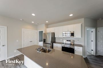 Cullman house for rent - A modern kitchen with a large island and stainless steel appliances.