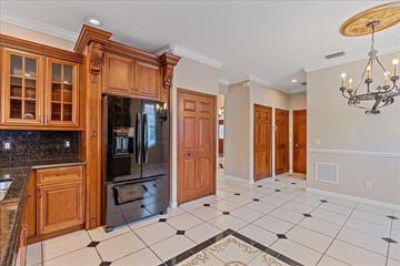 Sarasota house for rent - A kitchen with wooden cabinets and a black and white checkered floor.