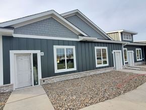 Grinnell apartment for rent - a green house with a white door and a gravel driveway