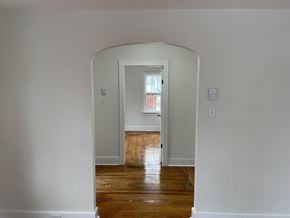 New Glasgow apartment for rent - a living room with white walls and a door way to a room with a window