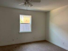 Killeen apartment for rent - an empty room with a window and a ceiling fan