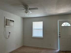Killeen apartment for rent - an empty room with a ceiling fan and a window