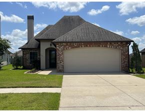 Lafayette house for rent - a white garage door on a brick house