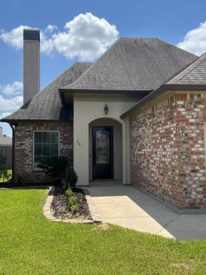 Lafayette house for rent - the front of a brick house with a sidewalk and grass