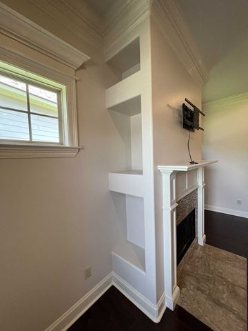 Lafayette house for rent - a living room with a fireplace and a staircase with a tv