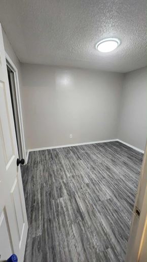 Killeen apartment for rent - A room with a grey carpet and a white door.