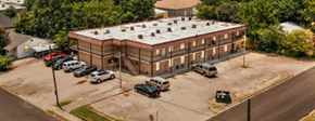Killeen apartment for rent - A parking lot with cars and a building in the background.