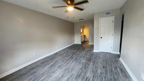 Killeen apartment for rent - A room with a ceiling fan and a door.