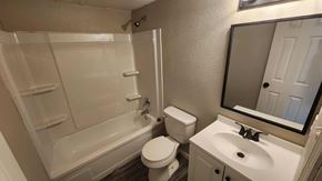 Killeen apartment for rent - A white bathroom with a toilet, sink, and bathtub.
