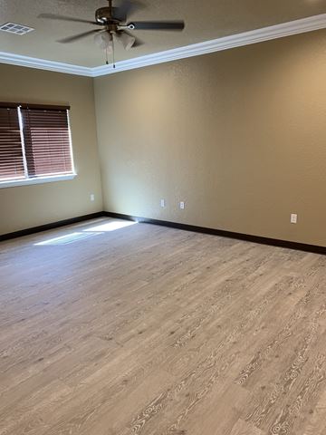 Durant house for rent - a living room with wood floors and a ceiling fan