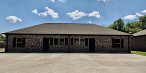 Durant house for rent - the front of a brick building with a driveway