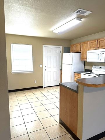 Durant apartment for rent - a kitchen with a white refrigerator and a sink