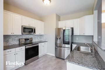 Clarksville house for rent - A kitchen with a stainless steel refrigerator and microwave oven.