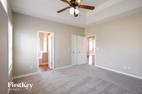 Clarksville house for rent - A spacious room with a ceiling fan and two doors.